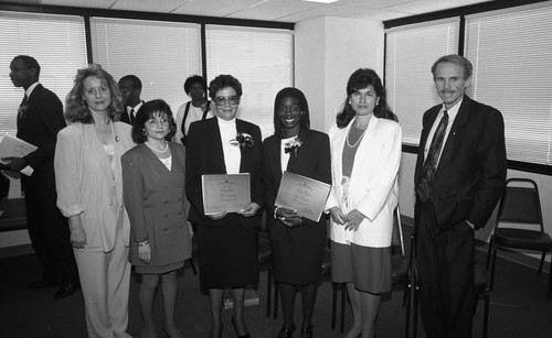 Attendees of the Financial Employment Center grand opening posing together, Los Angeles, 1993