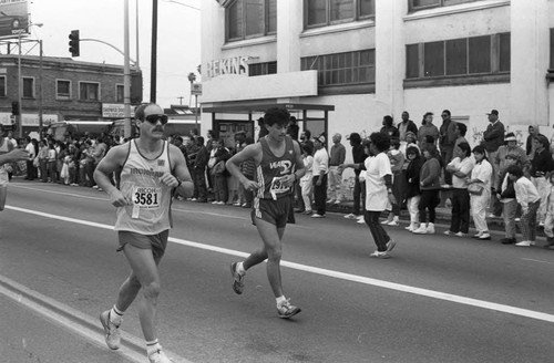 Runners passing spectators on Crenshaw Blvd. during the first LA Marathon, Los Angeles, 1986