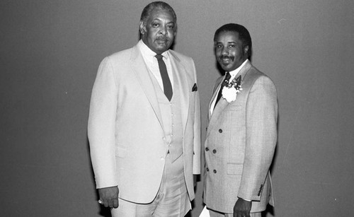 James Cleaver posing with Rev. Dr. Charles H. Belcher during the Los Angeles Alumnae Chapter of Delta Sigma Theta "Founders Day" event, Los Angeles, 1986