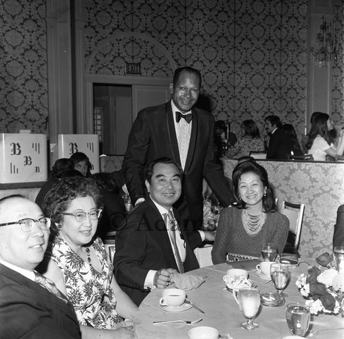 Tom Bradley posing with guests during an event in his honor, Los Angeles, 1972