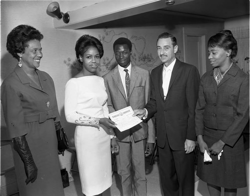 Bride and groom receiving their marriage certificate, Los Angeles, 1965