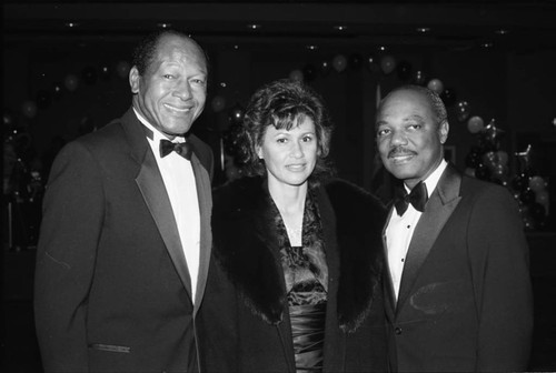 Tom Bradley posing with supporters at a dinner, Los Angeles, 1989