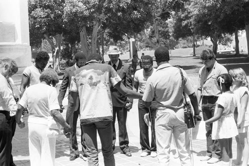 Rev. Bill Minson and others praying together near L.A. City Hall, Los Angeles, 1983