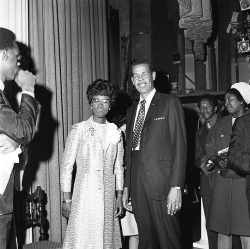 Shirley Chisholm posing with an unidentified man at the Wilshire Ebell Theatre, Los Angeles, 1970