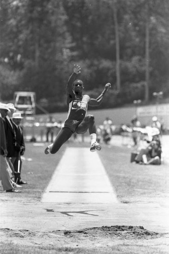 Carl Lewis completing a long jump, Los Angeles, 1982