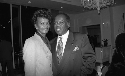 Lou Rawls posing with a woman during his "Parade of Stars" telethon, Los Angeles, 1994