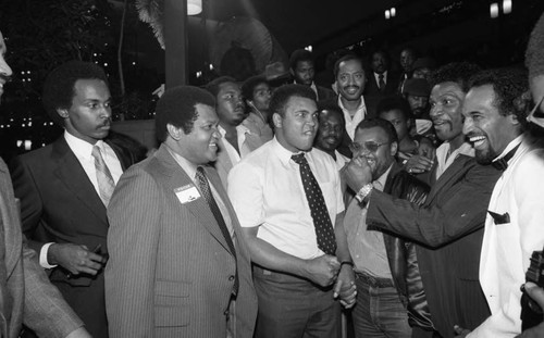 Muhammad Ali preparing for a playful punch from Mike Weaver, Los Angeles, 1982