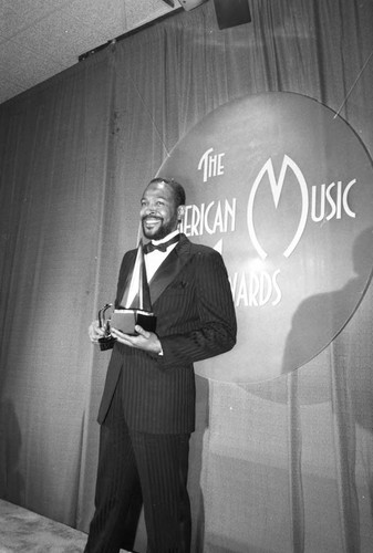 Marvin Gaye posing with his award at the 10th Annual American Music Awards, Los Angeles, 1983