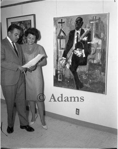 Man and woman examine documents, Los Angeles, 1964