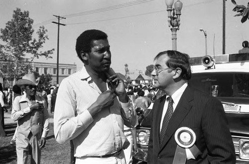 Willis Edwards talking with Robert Philibosian during the 16th annual Easter parade, South Central Los Angeles, 1984