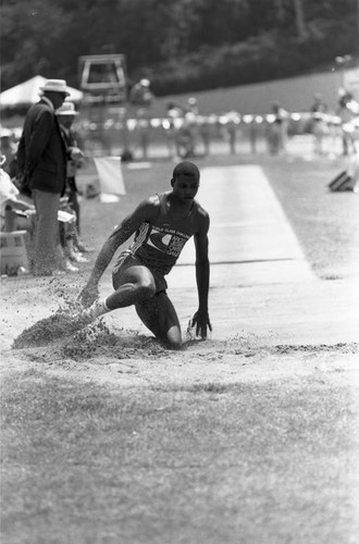 Carl Lewis completing a long jump, Los Angeles, 1982