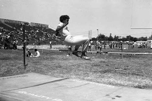 Young woman performing a high jump during the Compton Track and Field Championship, 1984