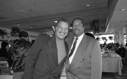 Frank Holoman posing with Reynaldo Rey at the opening of the restaurant, Frank's Place, Los Angeles, 1998