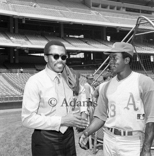 John "Blue Moon" Odom greeting an unidentified man at Anaheim Stadium, Los Angeles, 1969