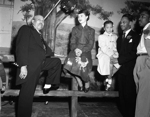 Bishop Charles Manuel "Sweet Daddy" Grace posing with the family of Charles Williams, Los Angeles, 1950