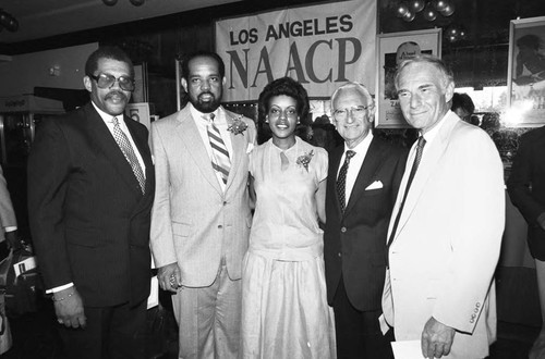 Guests at the premiere of "The Jesse Owens Story" posing together, Los Angeles, 1984