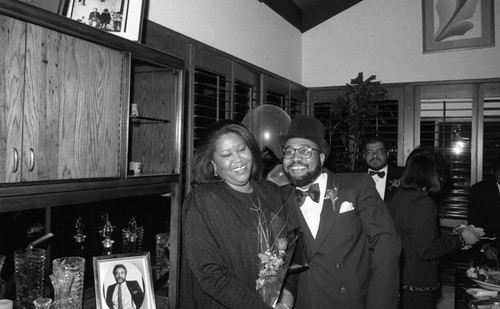 Guests at a formal event at a private home posing together, Los Angeles, 1990