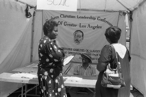 Black Agenda Business Fair participants talking at the SCLC table, Los Angeles, 1986