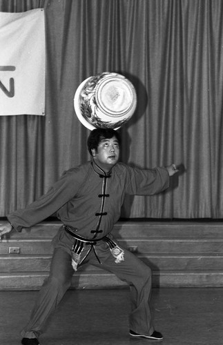 Chinese acrobat balancing a pot on his head, Los Angeles, 1985