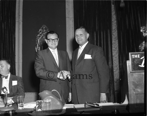 Two men shaking hands, Los Angeles, 1963