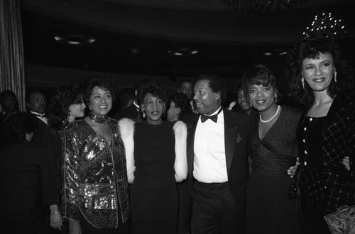 Oprah Winfrey posing with others at a Black Women's Forum event, Los Angeles, 1989