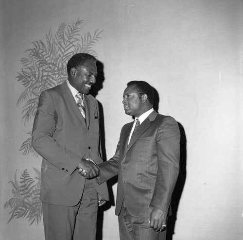 Two unidentified men shaking hands during a celebration of the new Kearny Post Office, Los Angeles, 1972