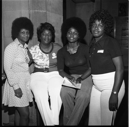 African American young women posing by a masonry pillar, Los Angeles, 1972