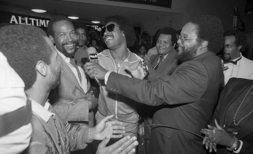 Broadcasters interviewing Marvin Gaye and Stevie Wonder during an event at Fox Hills Mall, Los Angeles 1982