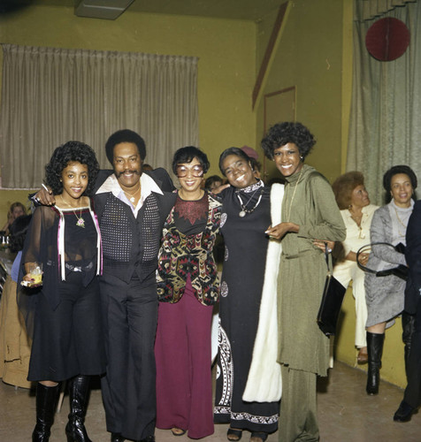 Gertrude Gipson posing with the hosts of a Super Bowl party, Los Angeles, 1977