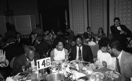 Guests sitting together at a dinner honoring Governor Deukmejian, Los Angeles, 1985