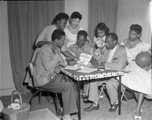 Men and women at a table, Los Angeles, 1956