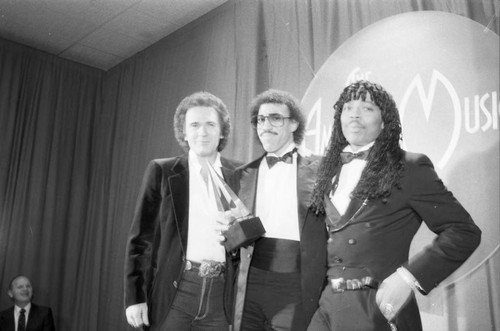 Lionel Richie posing with Rick James and T. G. Sheppard at the American Music Awards, Los Angeles, 1983