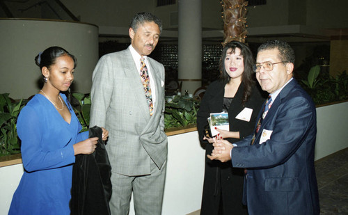 Atkins & Evans holiday party guests talking with Nelson L. Atkins, Los Angeles, 1994