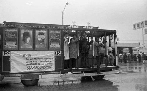 Old Forester representatives waving from a streetcar during the Compton Christmas Parade, Compton, 1983