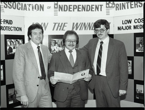 Association of Independent Printers event attendees near a display, Los Angeles, 1986