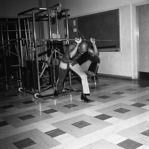 Man exercising at the Compton College gym, Compton, 1972