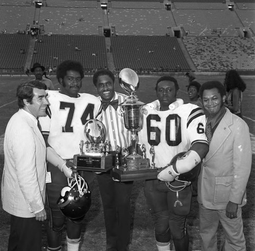 Grambling College football team members receiving Urban League Freedom Classic trophies, Los Angeles, 1973