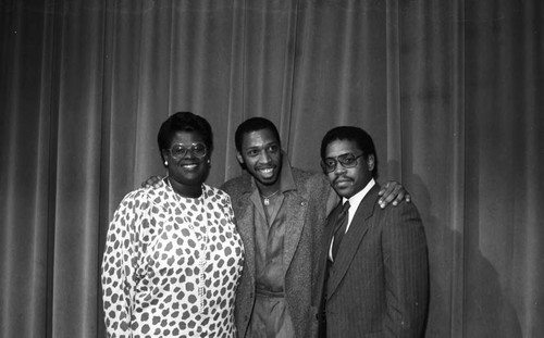 Jeffrey Osborne posing with others after a press conference, Los Angeles, 1985