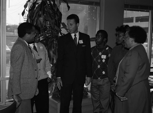 NAACP President Raymond Johnson, Jr. talking with others, Los Angeles, 1985