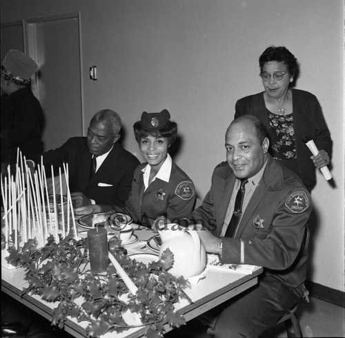 Deputy Helena Ashby and Lt. Onan Bomar attending the Women's Sunday Morning Breakfast Club Christmas meeting, Los Angeles, 1966