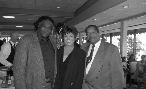 Frank Holoman posing with others at the opening of his restaurant, Frank's Place, Los Angeles, 1998