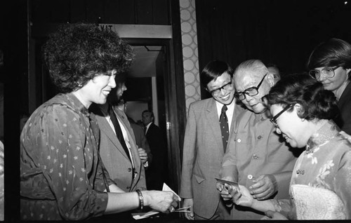 President Li Xiannian receiving a business card from an unidentified woman, Los Angeles, 1985