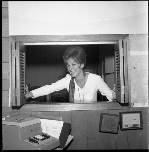 Woman posing in an office window, Los Angeles, 1971