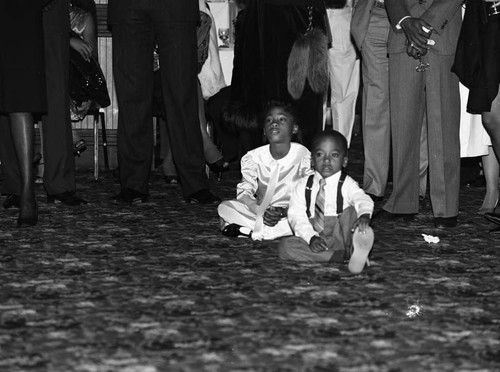 Award nominee's children sitting on a carpeted floor, Los Angeles, 1985