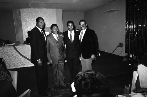 Tom Bradley and David S. Cunningham, Jr. posing with others at a Black Public Relations Club event, Los Angeles, 1985