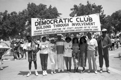 New Frontier Democratic Club members holding a banner during the Black Family Reunion, Los Angeles, 1989