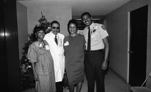 Christopher C. Dotson posing with others during a health care screening event, Los Angeles, 1984