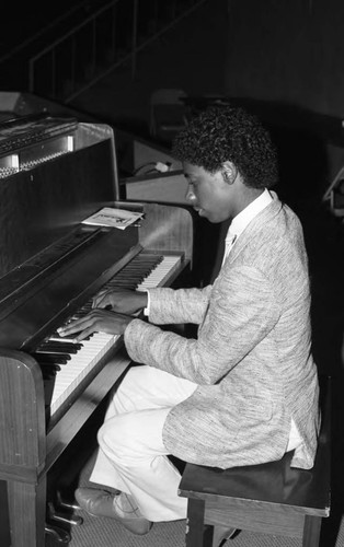 Young man playing the piano at the California Museum of Science and Industry, Los Angeles, 1986