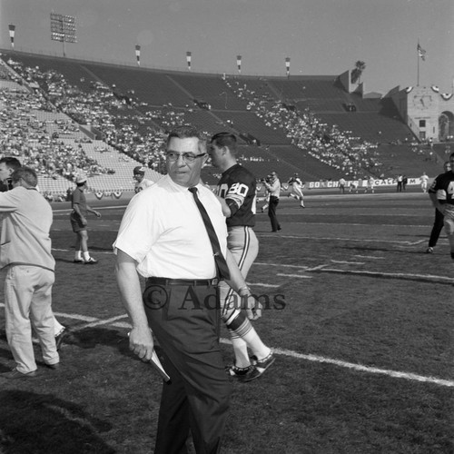 Vince Lombardi walking across the field at Los Angeles Memorial Coliseum, Los Angeles, 1967