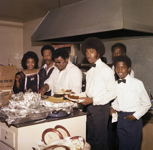 Herb and Connie Thompson posing with catering staff for their Super Bowl party, Los Angeles, 1977